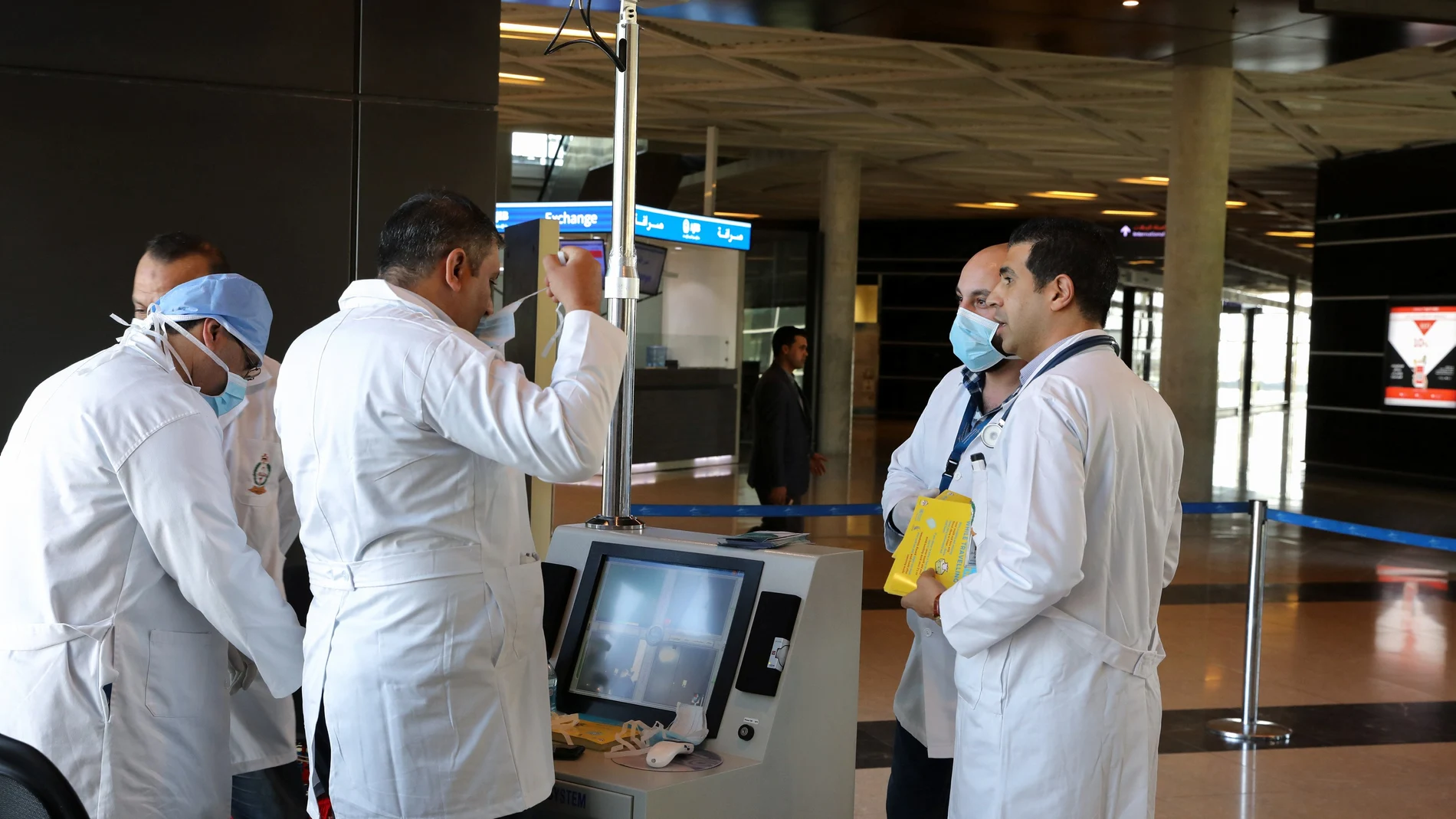 Medical staff prepare to check passengers for coronavirus symptoms at Queen Alia International Airport in Amman