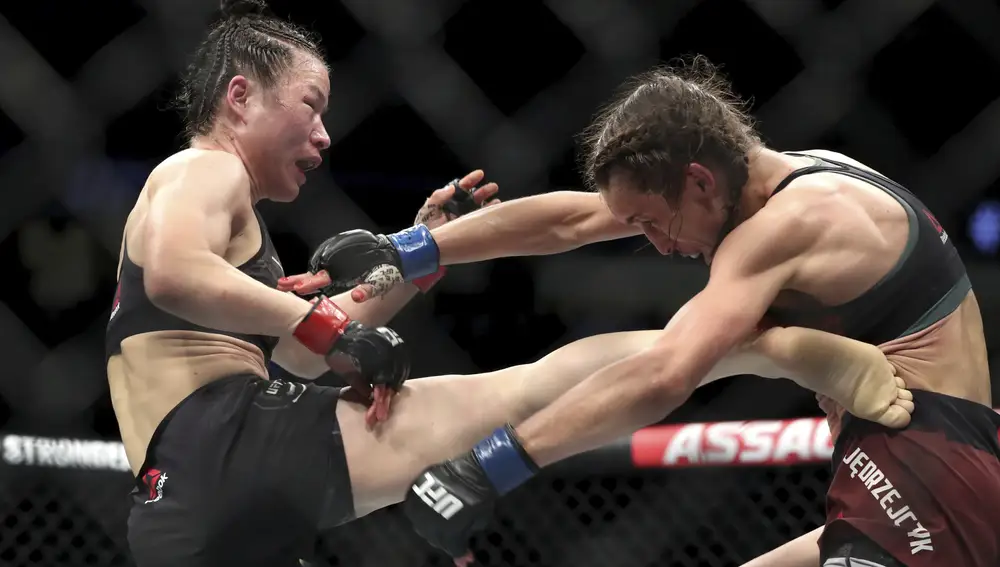 UFC women's strawweight champion Weili Zhang, left, of China kicks former champion Joanna Jedrzejczyk of Poland during UFC 248 at T-Mobile Arena in Las Vegas Saturday, March 7, 2020. (Steve Marcus/Las Vegas Sun via AP)