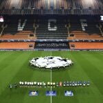 Atalanta and Valencia players line up ahead of the Champions League round of 16 second leg soccer match between Valencia and Atalanta in Valencia, Spain, Tuesday March 10, 2020. The match is being in an empty stadium because of the coronavirus outbreak. (UEFA via AP)