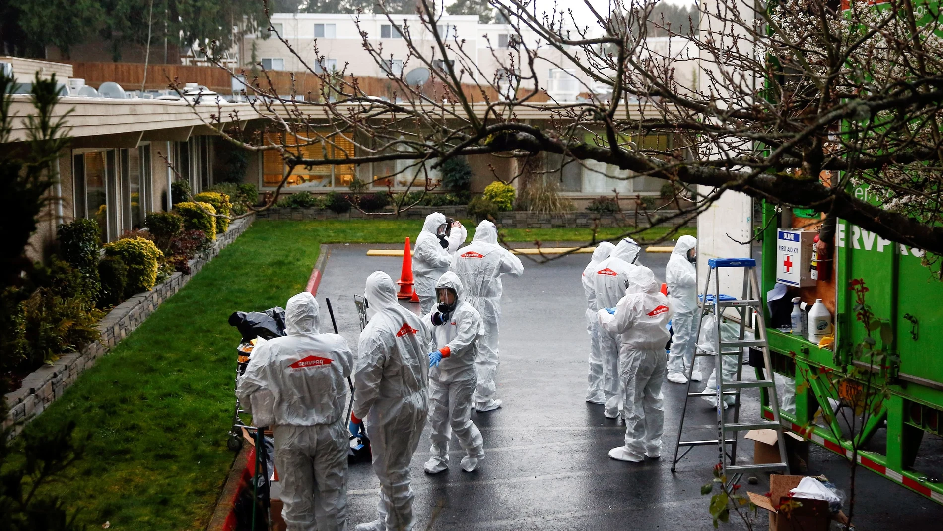 A Servpro cleaning crew puts on protective gear before entering Life Care Center of Kirkland
