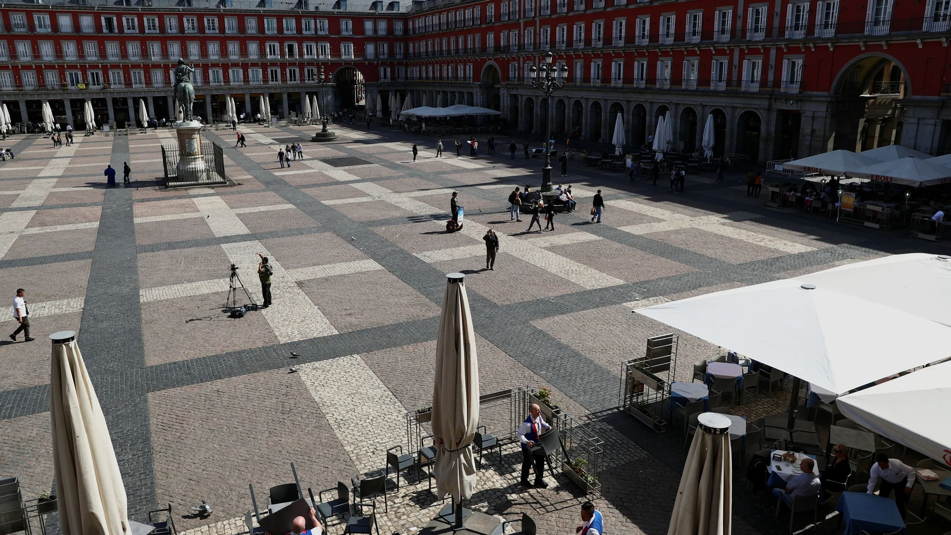 Workers remove the terrace of a restaurant due to the coronavirus outbreak at Plaza Mayor in Madrid