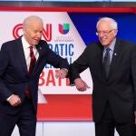 El vicepresidente Joe Biden y el senador Bernie Sanders se saludan con el codo en su último debate