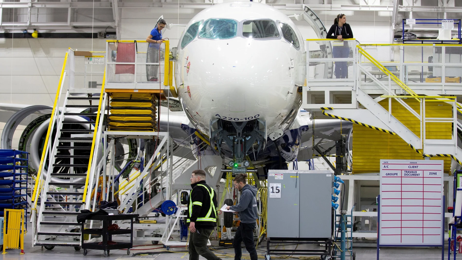 FILE PHOTO: Employees work on an Airbus A220-300 at their facility in Mirabel