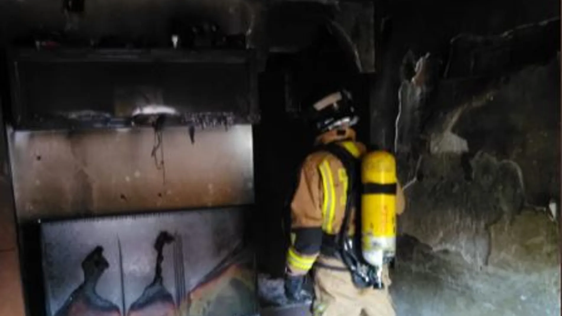 Los bomberos en una vivienda incendiada
