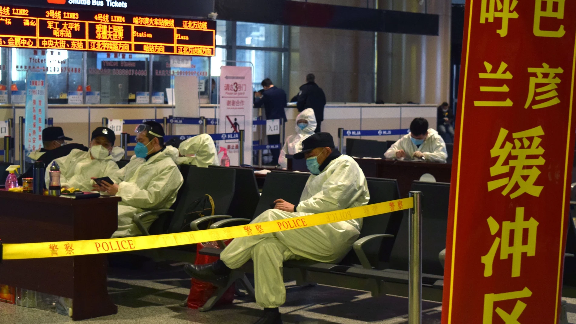 Police officers in protective suits are seen at an aiport in Harbin, capital of Heilongjiang province bordering Russia, following the spread of the novel coronavisurs disease (COVID-19) continues in the country