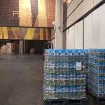 Mercadona entrega tres palets de botellas de agua mineral a los voluntarios sanitarios que descargan el material en Feria Valencia