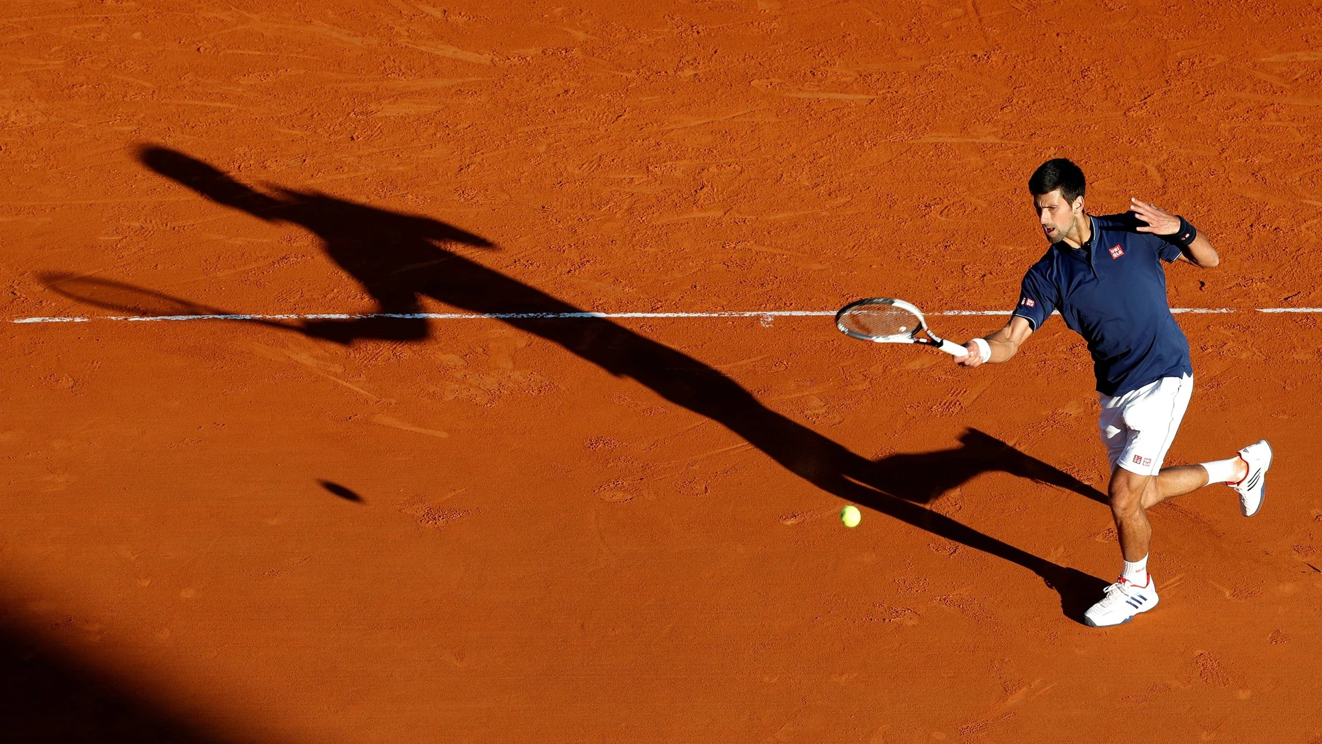 FILE PHOTO: Serbia's second seed Novak Djokovic plays a shot to Pablo Carreno Busta during his three-set victory over the Spaniard in the third round of the Monte Carlo Masters.