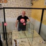 Un operario instala mamparas de protección en un bar, como una de las medidas de proteccion que se podrían adoptar ante un posible desescalamiento
