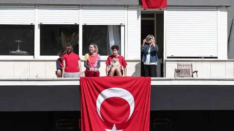 Una familia turca confinada en su casa de Estambul celebraeste jueves en el balcón el día de la soberanía nacional. La provincia junto a las 30 más importantes del país mantendrán un confinamiento hasta el 26 de abril