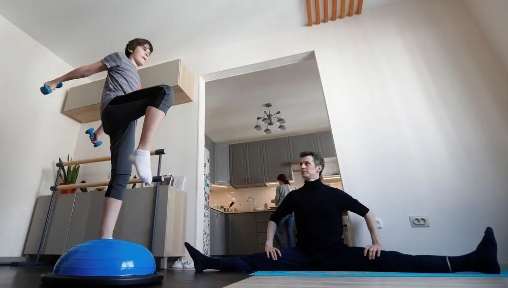 Mikhailovsky Theatre dancer Zaytsev and his son do the ballet class at home in Saint Petersburg