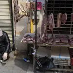 Un vendedor espera clientes en un puesto de Wuhan
