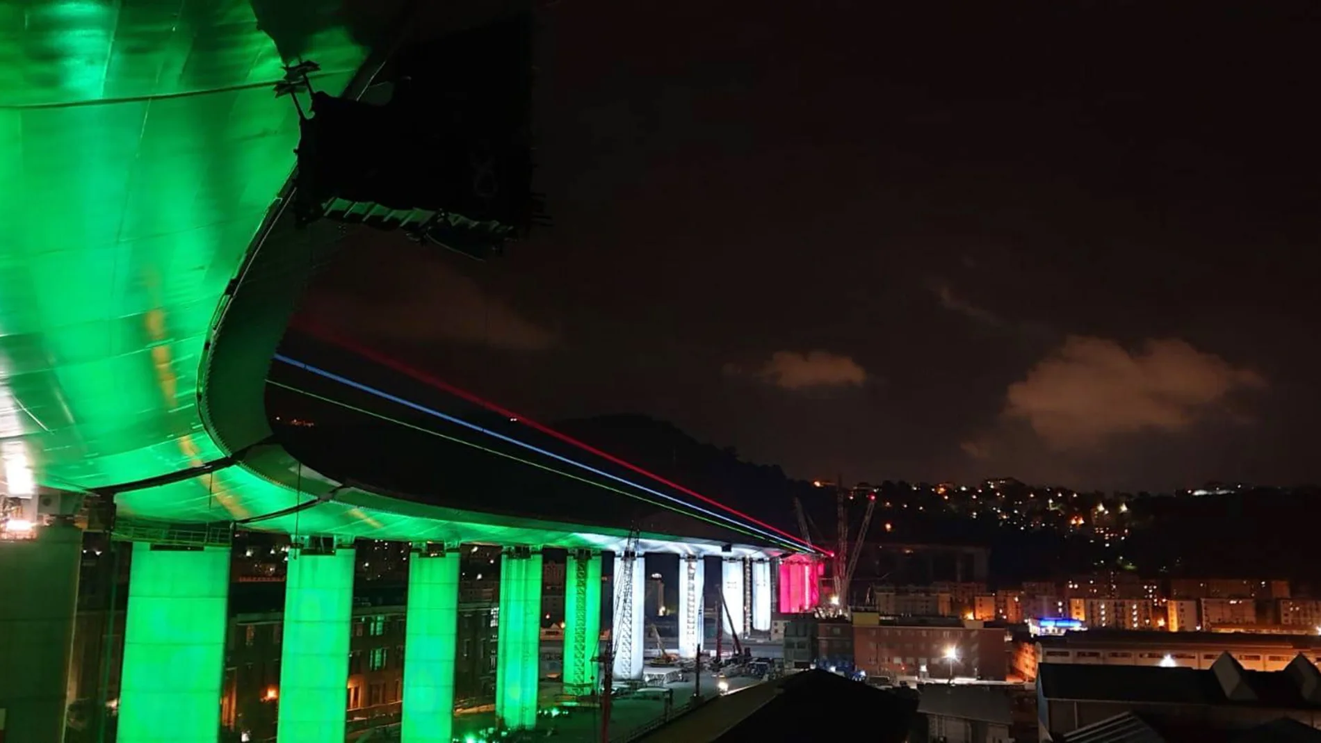 Genoa's collapsed bridge lit with colors of the Italian flag