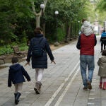 Una familia pasea por el Campo Grande de Valladolid el primer día que se les permitía salir a los niños