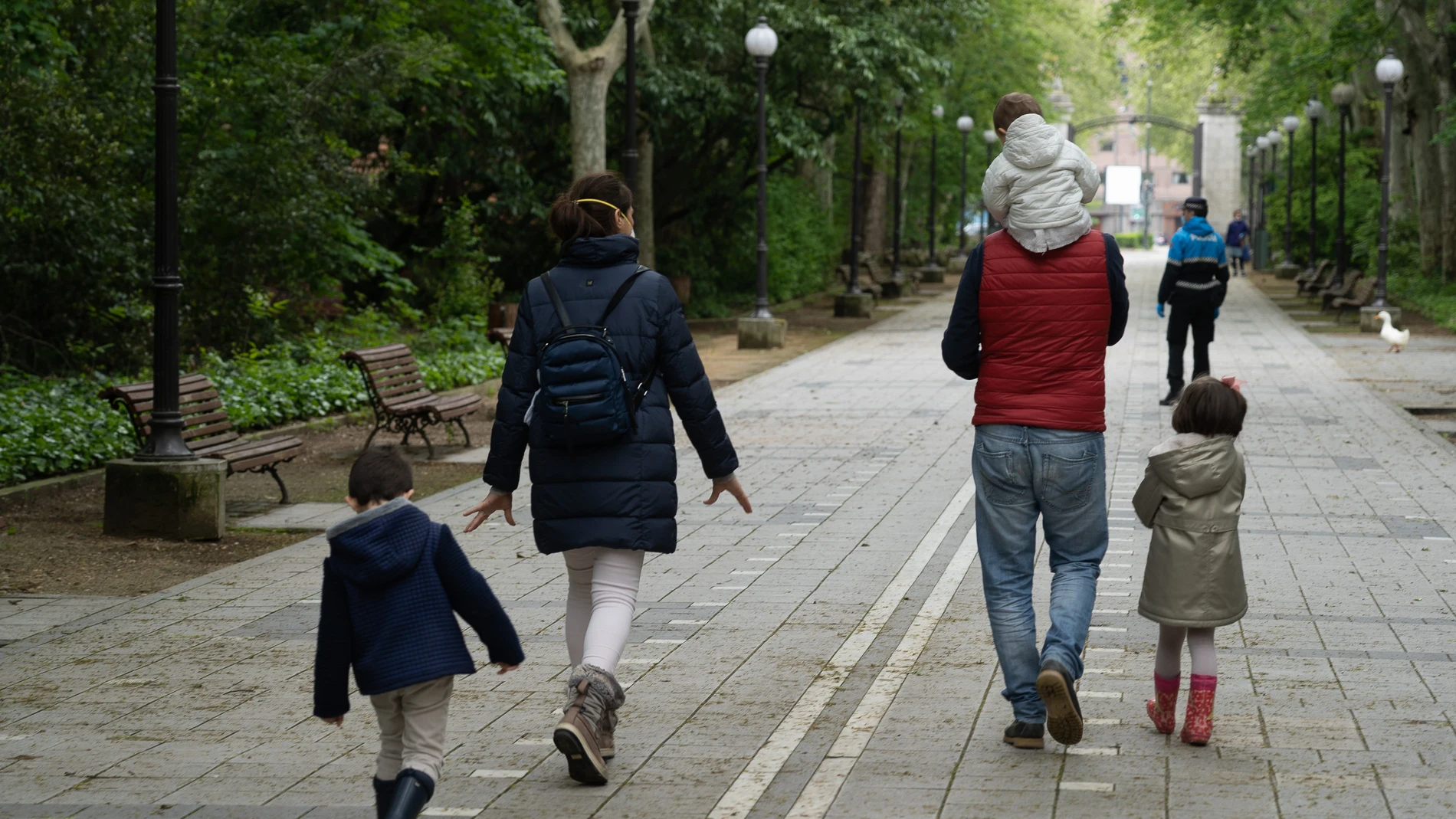 Una familia pasea por el Campo Grande de Valladolid el primer día que se les permitía salir a los niños