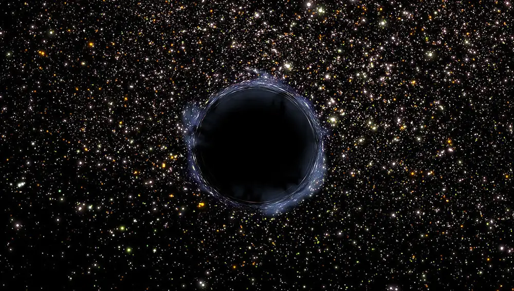 Si pudiésemos acercarnos mucho a un agujero negro y gozásemos de un cielo tan bonito como el de esta imagen, podríamos distinguir el agujero negro porque “tapa” la luz de las cosas que hay detrás. Pero eso no es porque el agujero negro sea sólido: es porque la luz que entra nunca vuelve a salir.