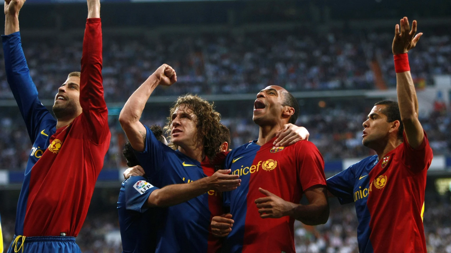 FILE PHOTO: Barcelona's Gerard Pique, Carles Puyol, Thierry Henry and Daniel Alves celebrate a goal in their 6-2 La Liga victory over Real Madrid at the Santiago Bernabeu stadium in Madrid.
