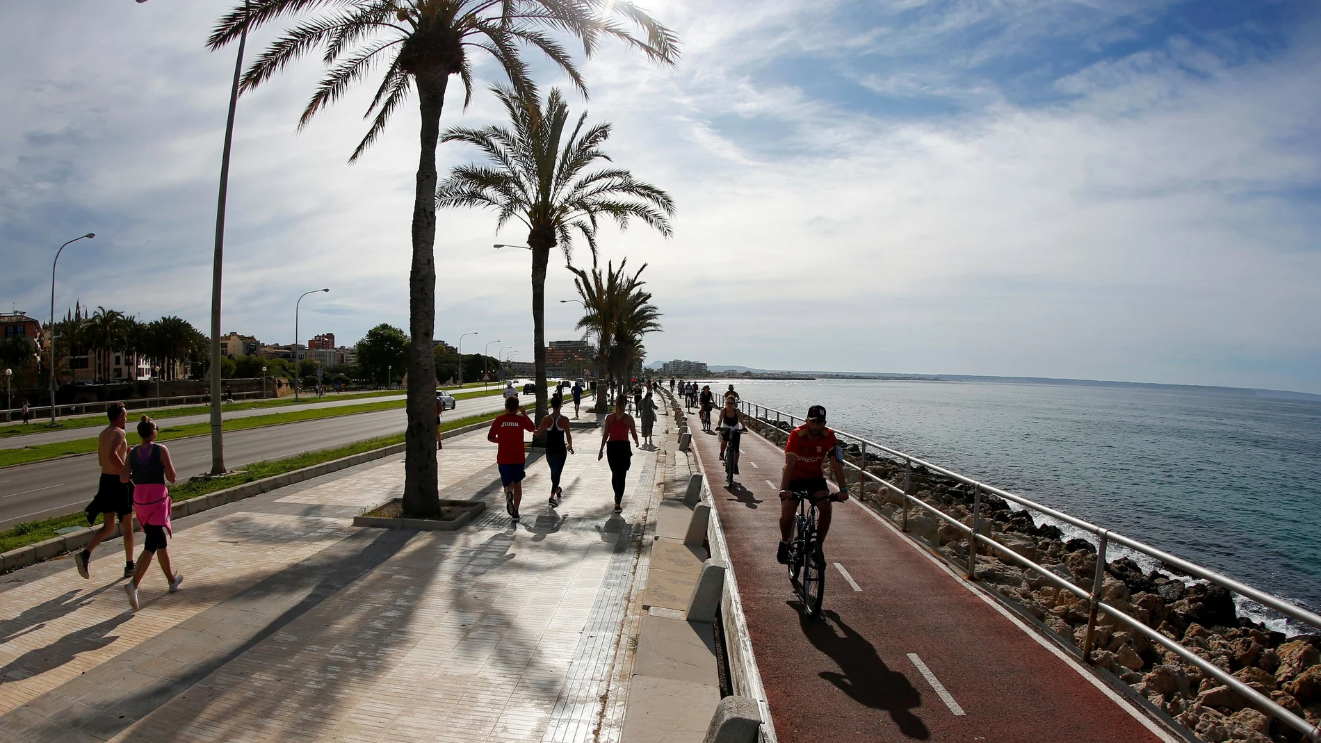 People practice sports on Palma de Mallorca sea promenade during the hours in which individual exercise is allowed outdoors