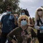 Supporters of Prime Minister Benjamin Netanyahu wear a masks amid concerns over the country's coronavirus outbreak during a protest by in front of Israel's Supreme Court in Jerusalem, Sunday, May 3, 2020. Israel's high court heard petitions Sunday that seek to block Prime Minister Benjamin Netanyahu from forming a government because he has been charged with serious crimes. (AP Photo/Tsafrir Abayov)