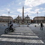 Viandantes pasean hoy por la plaza del Popolo de Roma