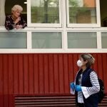 Roser Camps, de 83 años, usuaria fija de la residencia geriática "Fundació Sta Eulàlia", de L'Hospitalet de Llobregat (Barcelona) habla desde una ventana con su hija Yolanda. EFE/Toni Albir