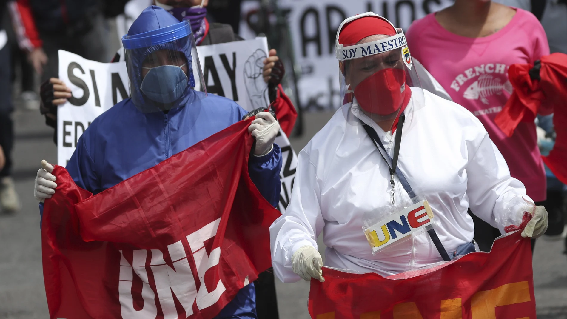 Central University teacher join students protesting education budget cuts, proposed by President Lenin Moreno to ease the economic pressure caused by the COVID-19 pandemic in Quito, Ecuador, Monday, May 11, 2020. (AP Photo/Dolores Ochoa)
