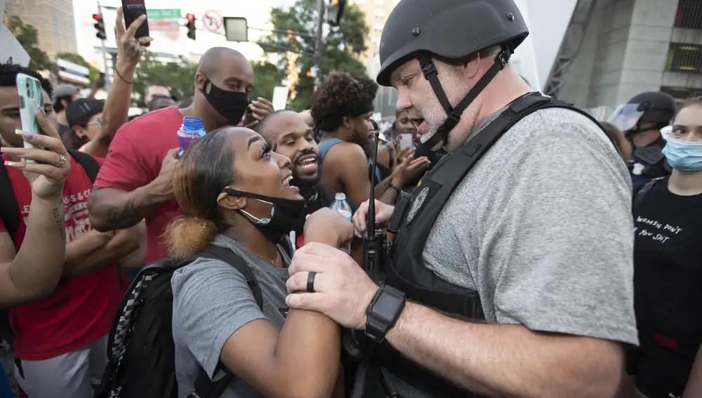 Un agente de Policía intenta calmar a una manifestante en Atlanta