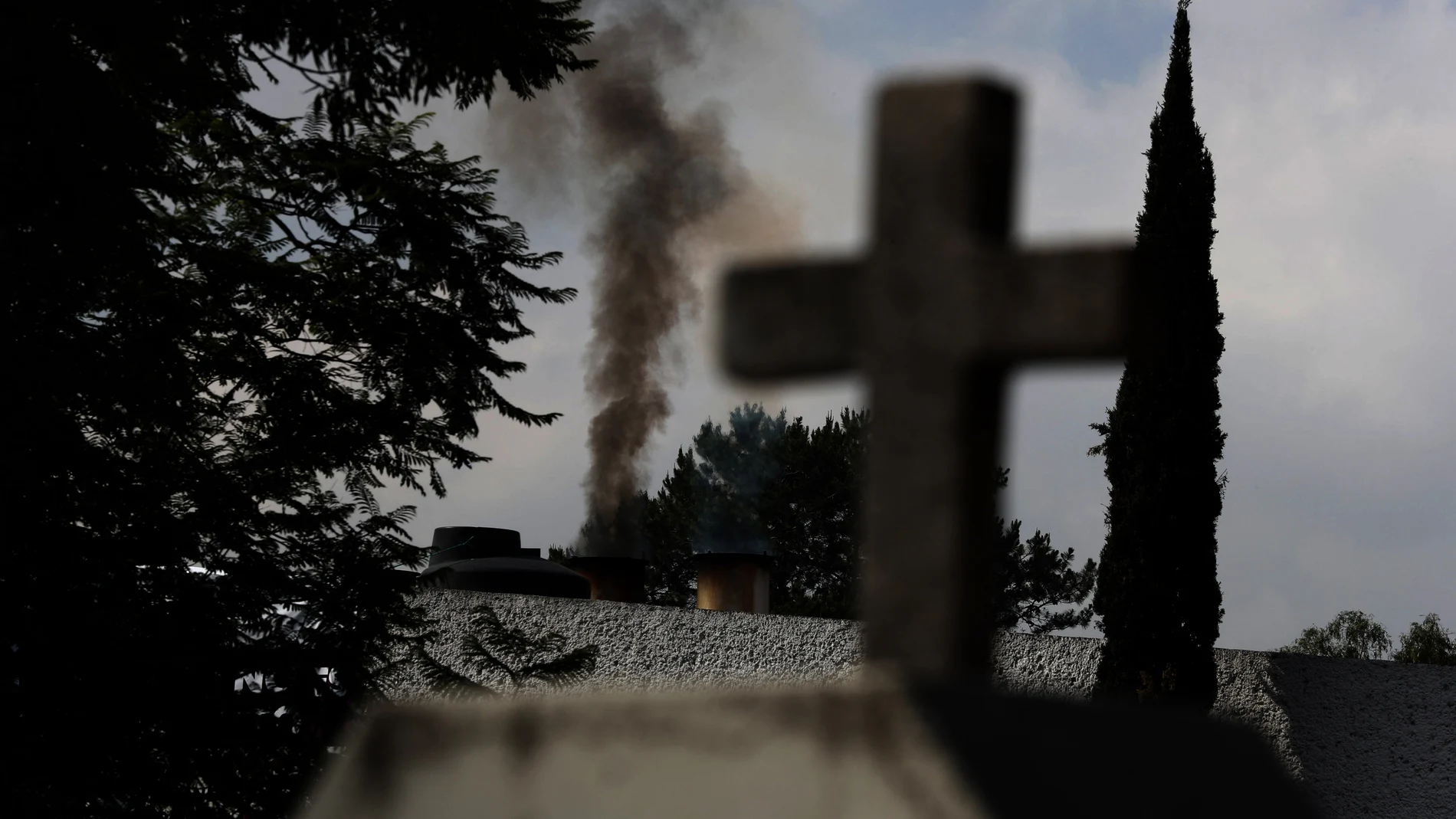 Smoke rises from the crematorium at the PanteÃ³n de San Nicolas Tolentino cemetery in the Iztapalapa neighborhood of Mexico City, Tuesday, June 2, 2020. Funeral parlors and crematoriums in Iztapalapa, a borough of 2 million people, say they have seen their work multiplied with the surging number of dead of COVID-19 in the capital's hardest-hit corner by the new coronavirus. (AP Photo/Marco Ugarte)