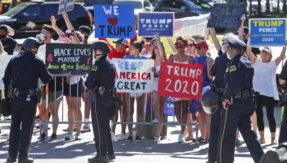 Un grupo de simpatizantes de Trump esperan al presidente a su llegada a Dallas