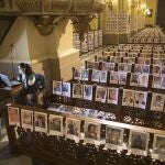 Camila Ronceros, worker of the press team of Lima's archdioceses, prints portraits of people who died due to the COVID-19, inside the Cathedral, in Lima, Peru, Saturday, June 13, 2020. Sunday's mass in Lima's cathedral with the presence of more than 4,000 portraits of the dead from COVID-19 is the first with these characteristics in the South American country where until Saturday more than 6,400 had died and more than 225,000 were infected. (AP Photo/Rodrigo Abd)