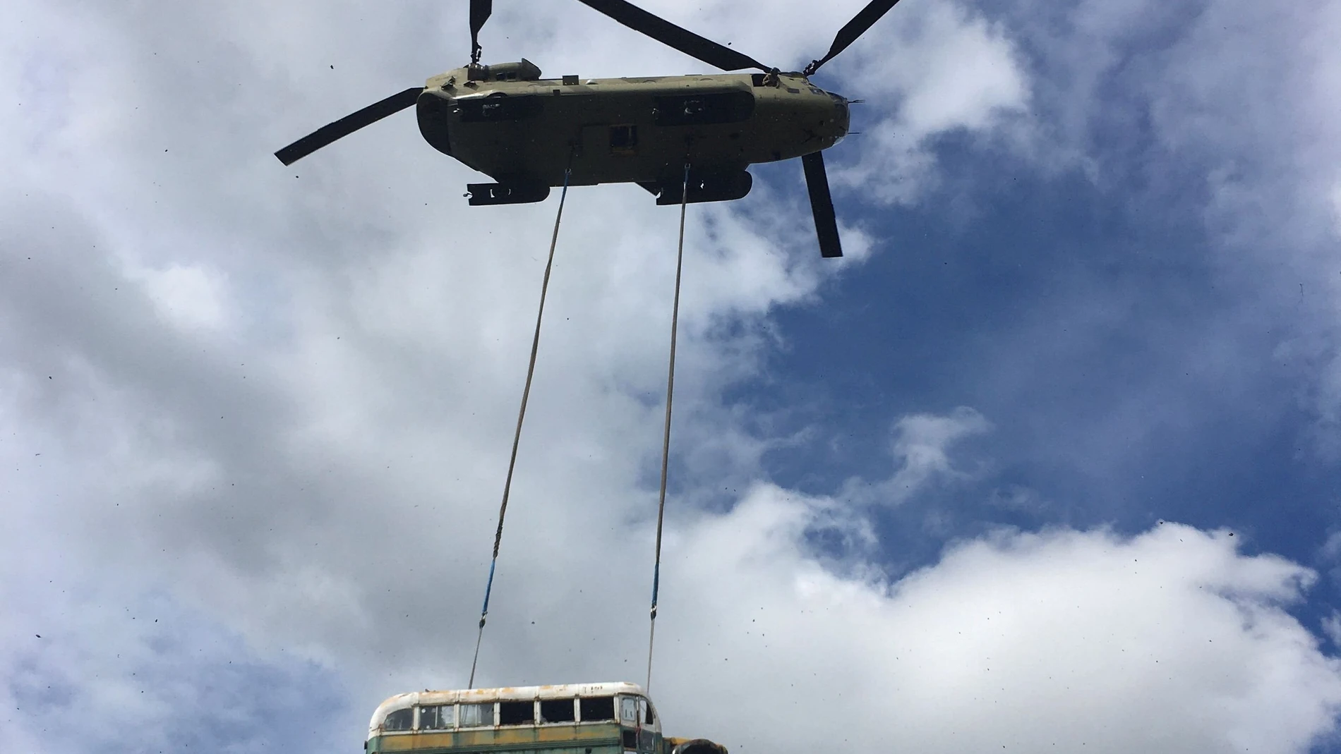 laska Army National Guard CH-47 Chinook helicopter carries the bus made famous by the "Into the Wild" book and movie near Stampede Trail