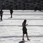 People walk in Quito's financial district in Ecuador, Monday, June 29, 2020. More than 150,000 state workers returned to work today amid fear of increasing COVID-19 infections and the capacity of hospitals to treat them. (AP Photo/Dolores Ochoa)