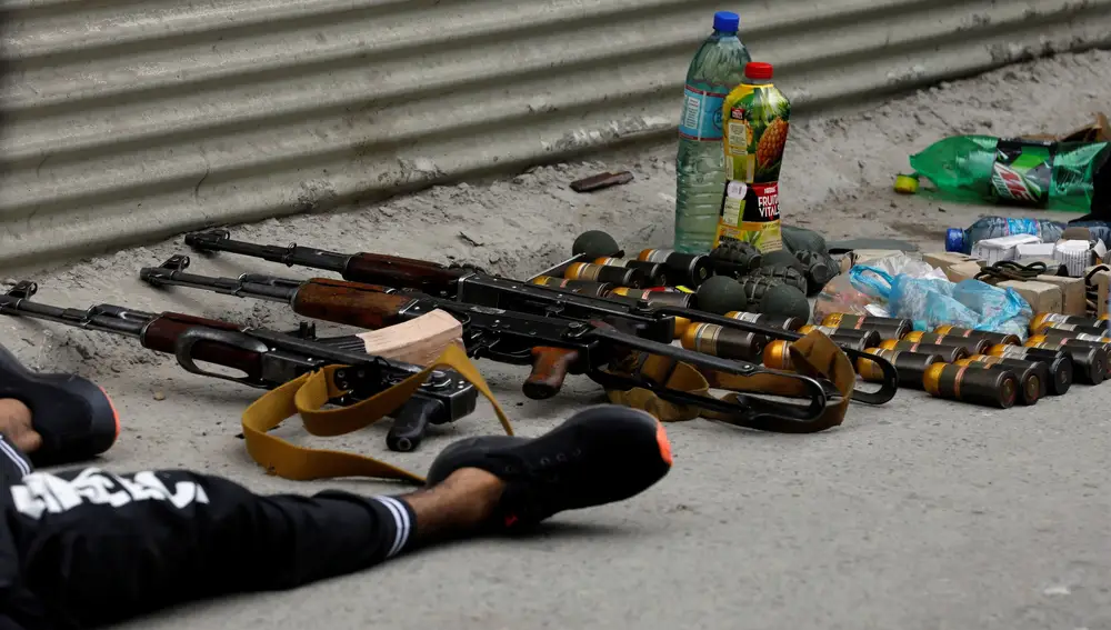 La munición y las armas que portaban los asaltantes junto al cuerpo de uno de los sospechosos