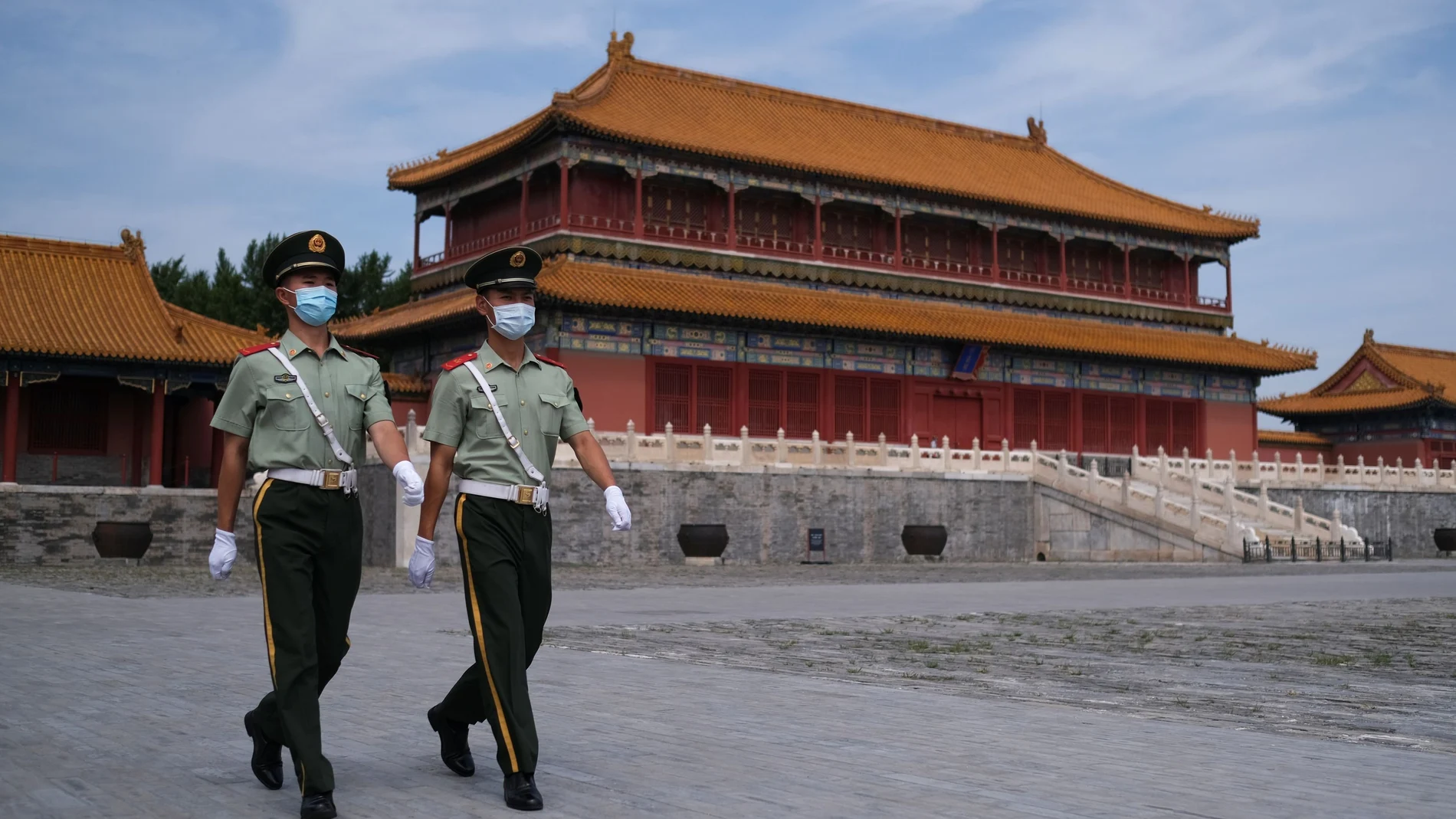 Paramilitary police officers wearing face masks walk at the Forbidden City following the outbreak of the coronavirus disease (COVID-19), in Beijing