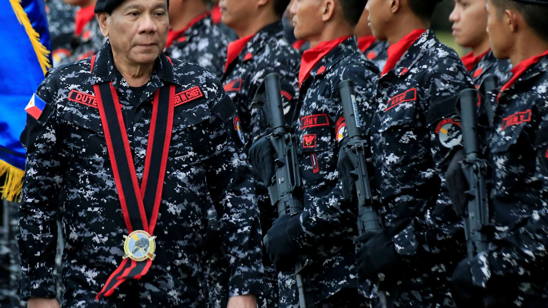 FILE PHOTO: Philippine President Rodrigo Duterte, wearing a military uniform, reviews scout ranger troops upon his arrival during the 67th founding anniversary of the First Scout Ranger regiment in San Miguel town, Bulacan province, north of Manila