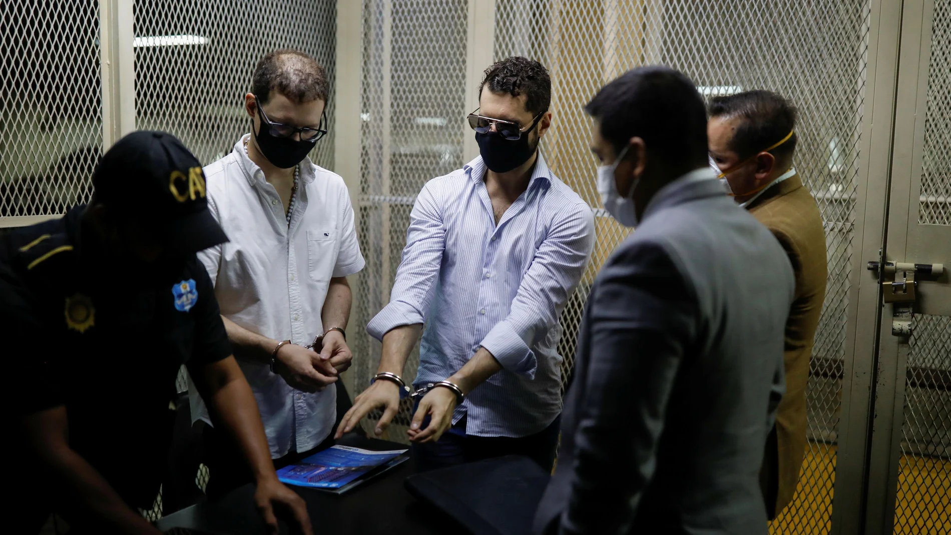 Ricardo (2nd L) and Luis Enrique, sons of former Panamanian President Ricardo Martinelli, are seen with their lawyers and a police officer after being detained to face extradition to the U.S. on money laundering charges, in Guatemala City