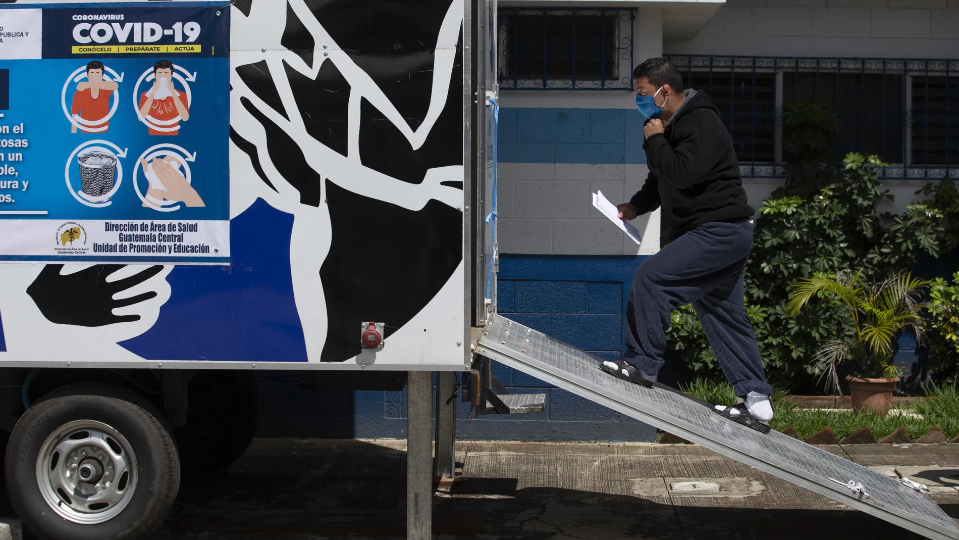 A deportee enters a mobile health clinic at the Immigration Institute shelter where Guatemalans deported from the U.S. are being held in quarantine, during a press tour in Guatemala City, Tuesday, July 7, 2020. According to the institute, more than 3,000 Guatemalans have been deported from the United States and 134 have tested positive for COVID-19 since the onset of the coronavirus emergency. (AP Photo/Moises Castillo)