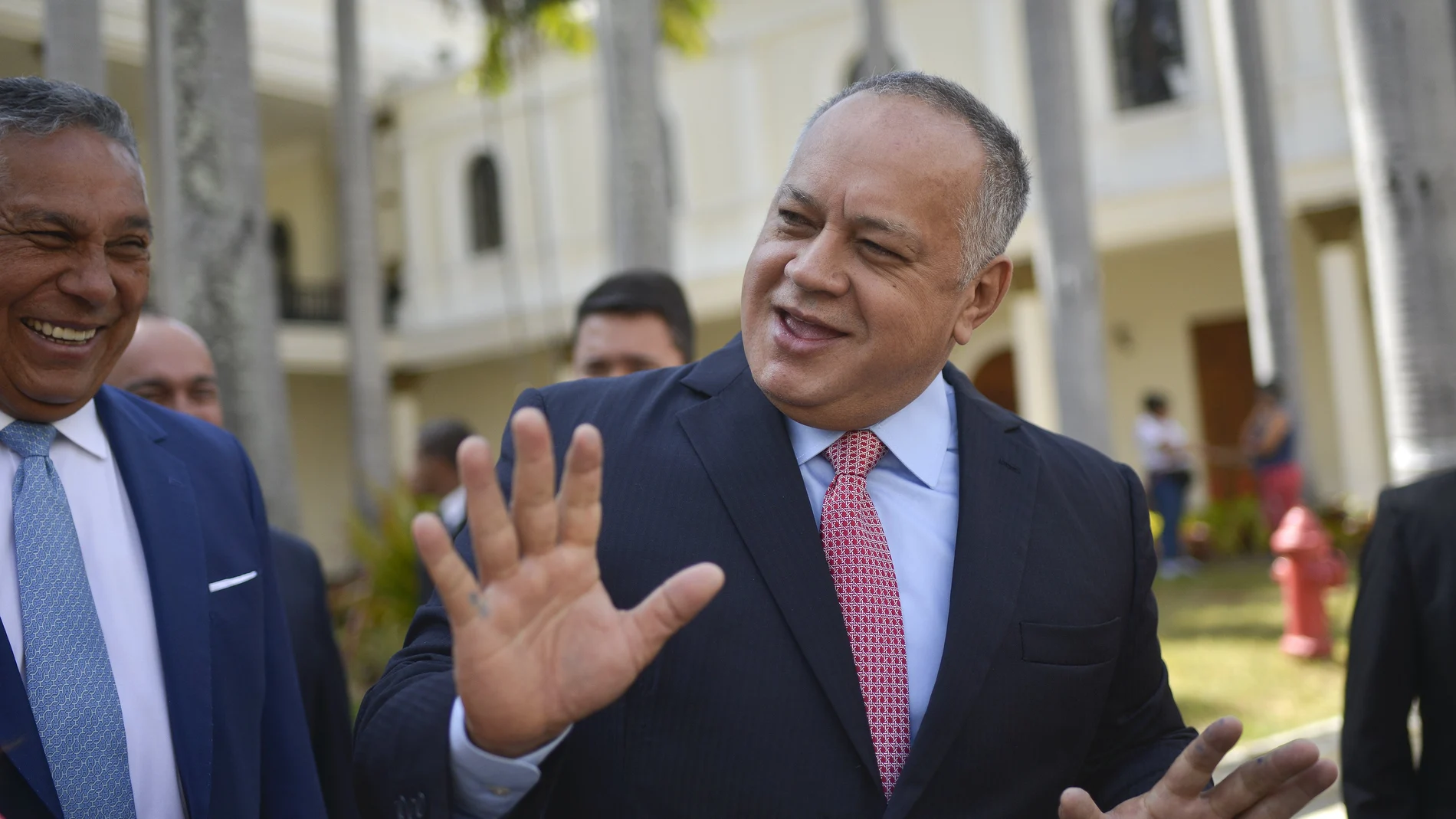 FILE- In this Jan. 8, 2020 file photo, Diosdado Cabello, president of the National Constituent Assembly, jokes with lawmakers after giving a press conference at the National Assembly in Caracas, Venezuela. Cabello has announced on Thursday, July 9, 2020, that he tested positive for COVID-19. (AP Photo/Matias Delacroix, File)