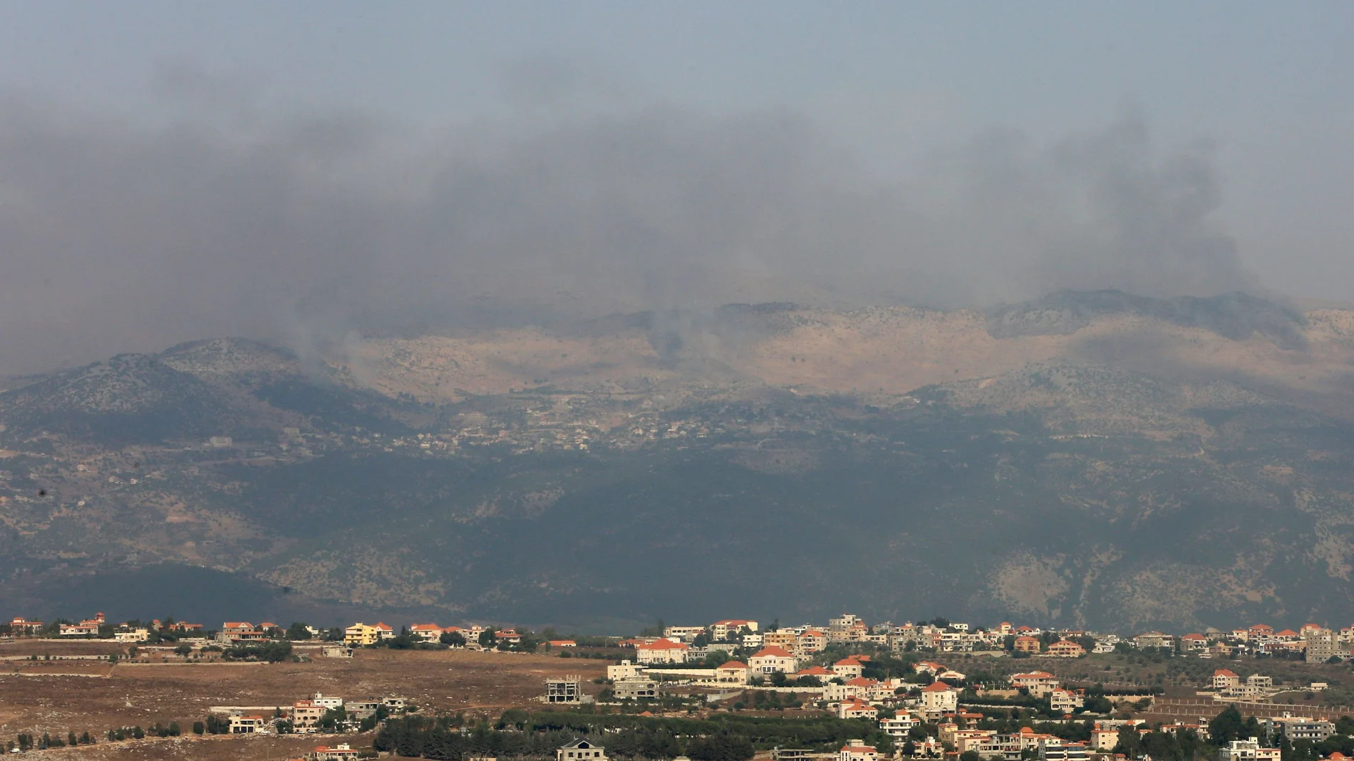 Smoke rises from the disputed Shebaa Farms area as seen from Marjayoun village
