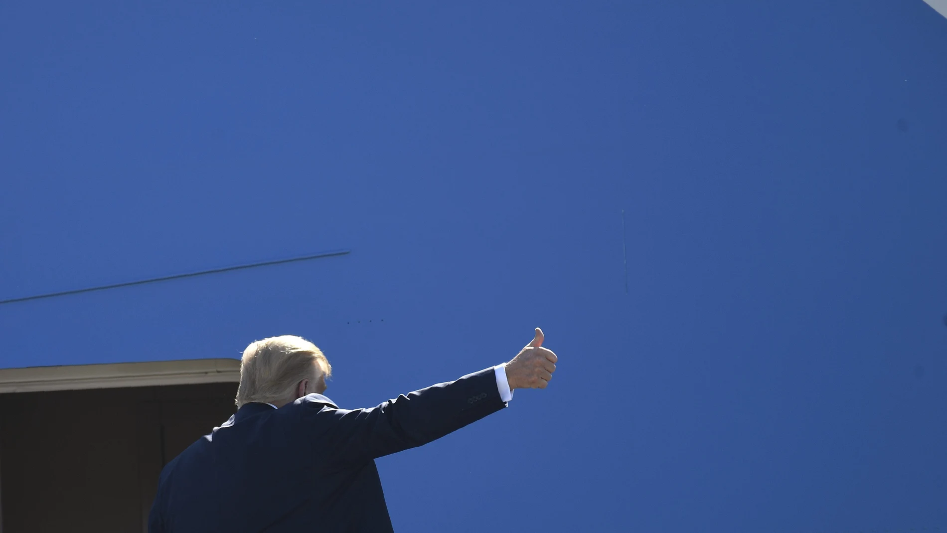 President Donald Trump gestures from the top of the steps as he boards Air Force One at Andrews Air Force Base in Md., Wednesday, July 29, 2020. Trump is heading to Texas and will shift focus to American energy dominance during a stop that will include his first visit to an oil rig. (AP Photo/Susan Walsh)