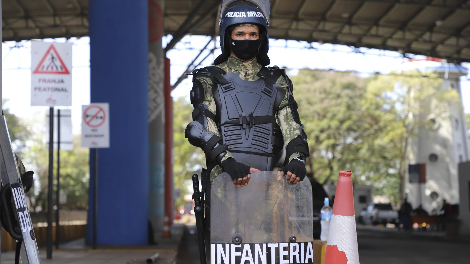 Navy marines stand guard at the entrance of Friendship Bridge that connects Ciudad Del Este, Paraguay, and Brazil's For do Iguazu, Thursday, July 30, 2020. Security was reinforced after Wednesday night's protests against a decreed near-total shutdown of the state, and on Thursday Paraguay eased the plans, allowing some businesses to operate during the day. (AP Photo/Marta Escurra)