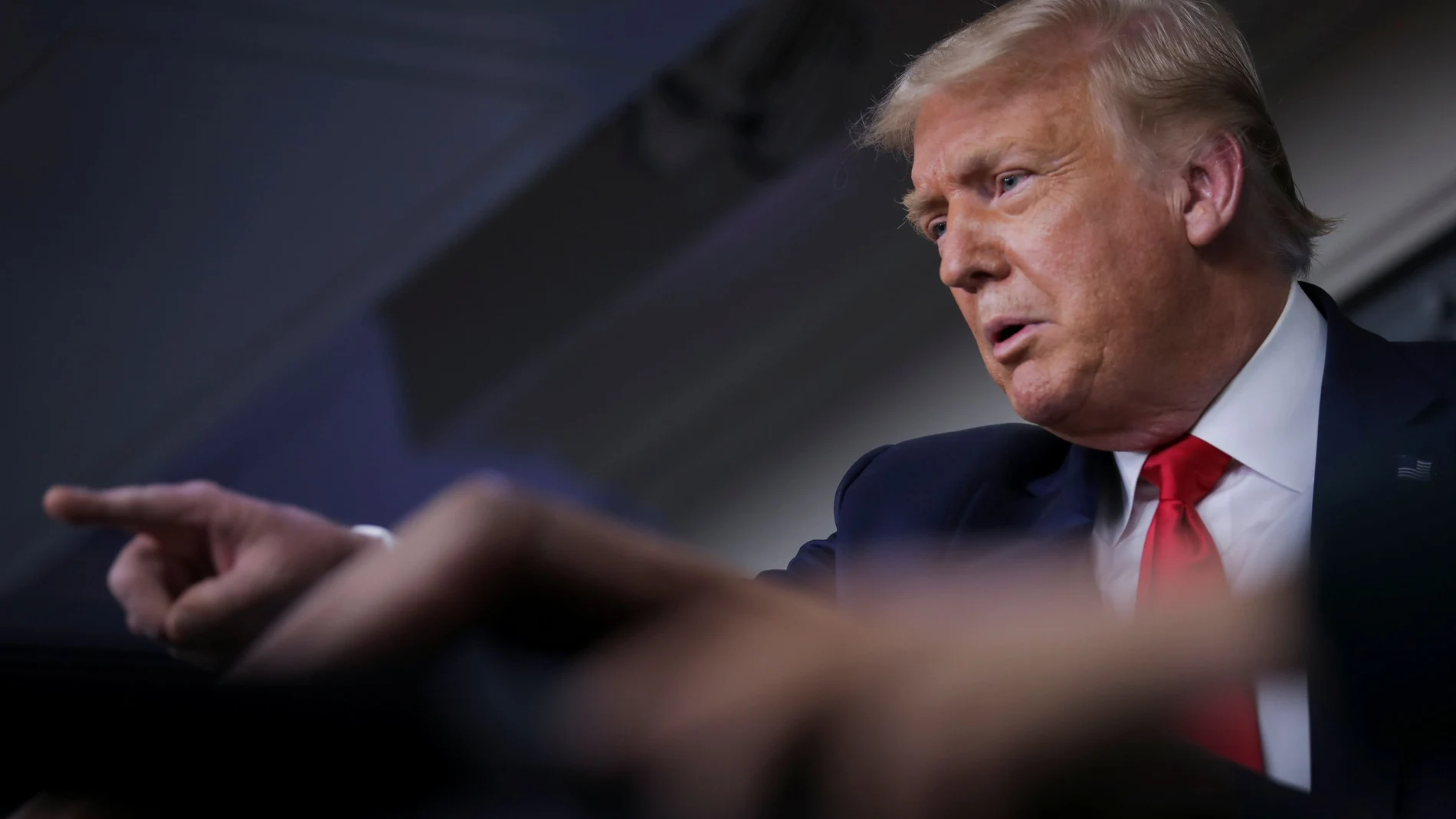 U.S. President Donald Trump points to a reporter as he answers questions during a coronavirus disease (COVID-19) task force news briefing at the White House in Washington, U.S., July 28, 2020. REUTERS/Carlos Barria