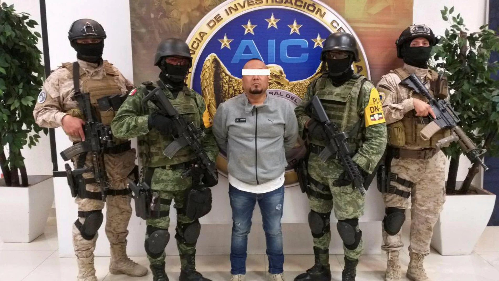 Members of the federal forces flank Jose Antonio Yepez in Guanajuato