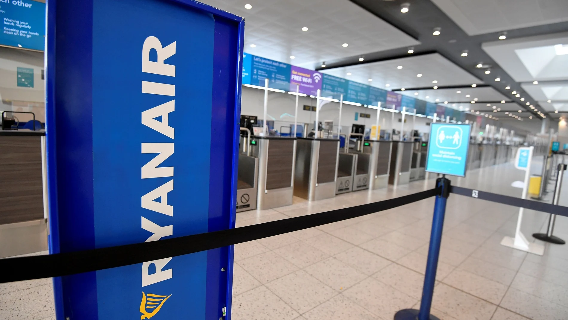FILE PHOTO: Ryanair sign is seen at the check-in area at Gatwick Airport, in Gatwick