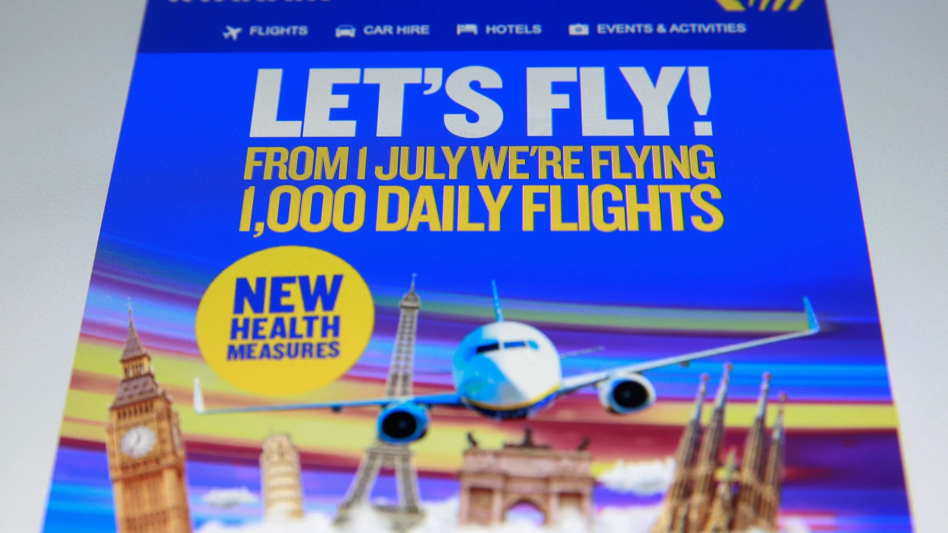 FILE PHOTO: An online advertisement for Ryanair, Europe's largest low-cost airline, states they are flying 1,000 daily flights from July 1 with new health measures, seen on a screen in London