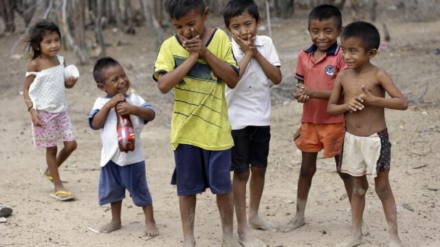 FILE - In this Sept. 10, 2015 file photo, Wayuu children play in Manaure, Colombia. A human rights group released a report Thursday, Aug. 13, 2020, warning that lack of access to clean water is leading to alarmingly high levels of child mortality and malnutrition among the Wayuu, Colombiaâ€™s largest Indigenous group. (AP Photo/Fernando Vergara, File)