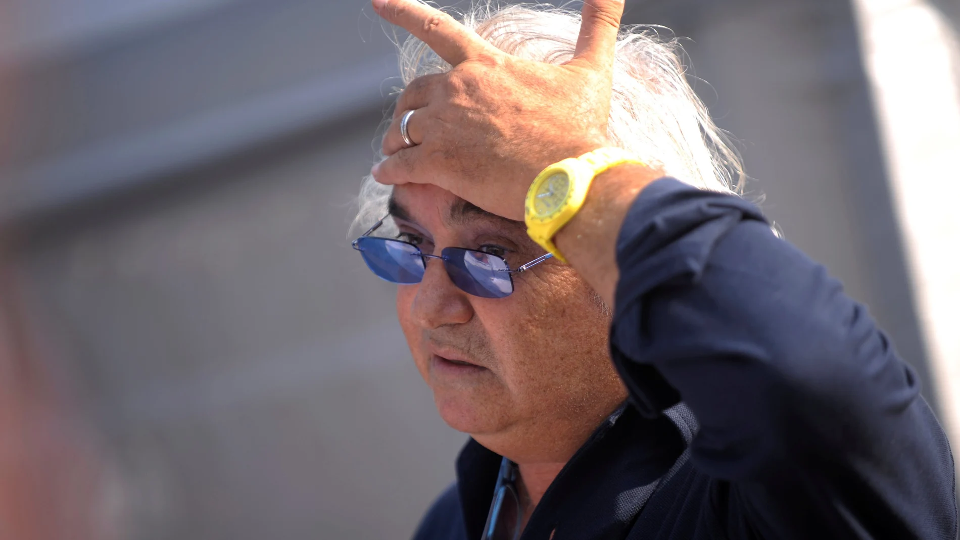 FILE PHOTO: Former Renault F1 principal Flavio Briatore gestures in the paddock after the qualifying session of the Italian F1 Grand Prix at the Monza circuit