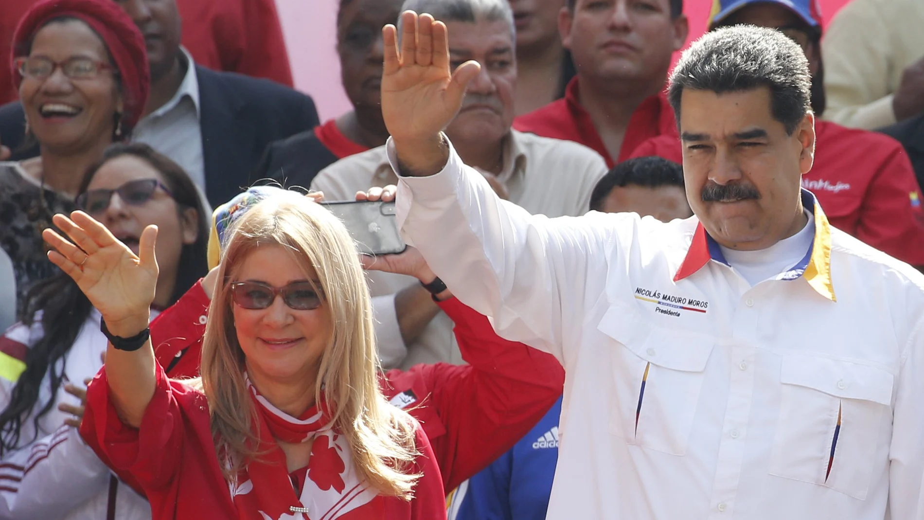 FILE - In this May 20, 2109 file photo, Venezuela's President Nicolas Maduro and his wife Cilia Flores wave to supporters outside Miraflores presidential palace in Caracas, Venezuela. A nephew of Venezuelaâ€™s first lady appealed on Tuesday, Aug. 25, 2020, to the U.S. Supreme Court an 18-year sentence for conspiring to smuggle 800 kilograms of cocaine into the U.S. (AP Photo/Ariana Cubillos, File)