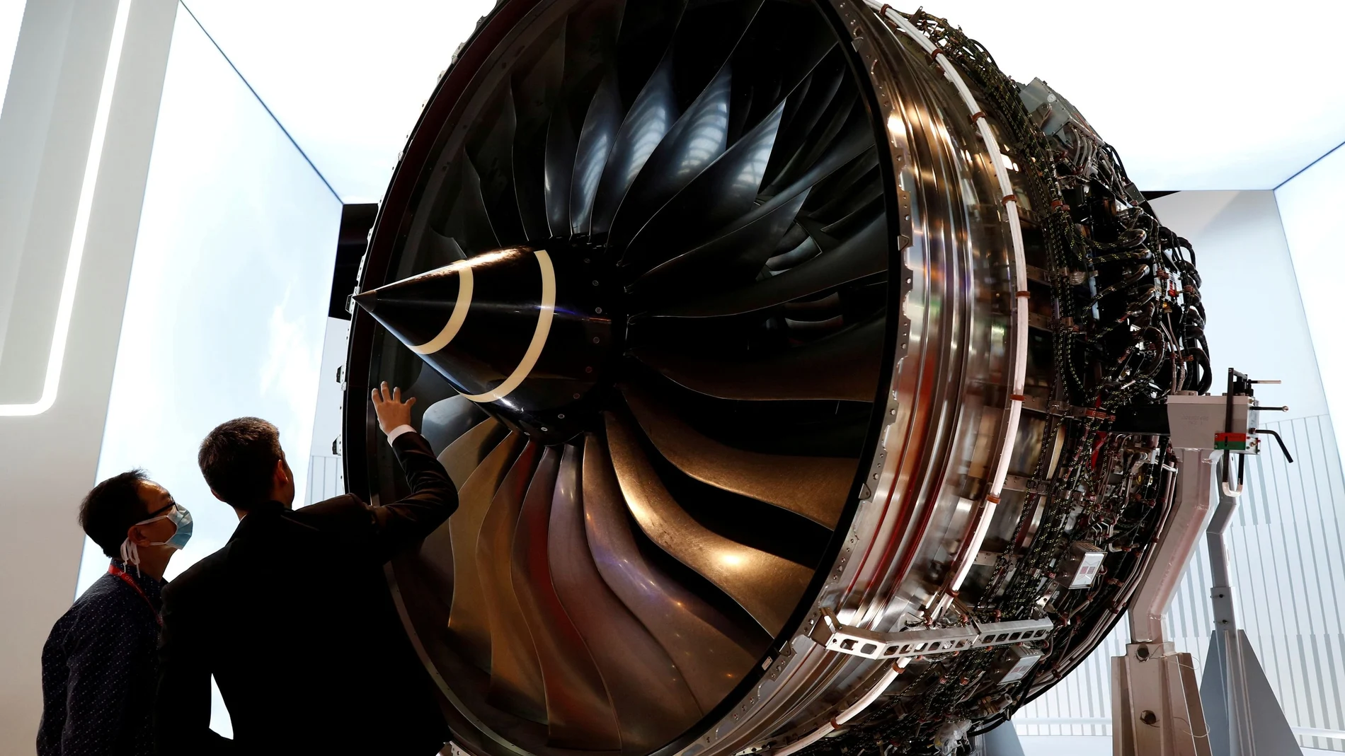 FILE PHOTO: A man looks at Rolls Royce's Trent Engine displayed at the Singapore Airshow in Singapore