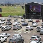 Catholic Priest Luis Carlos Ayala celebrates Mass at a drive-in as parishioners stay in their cars in Chia, Colombia, Sunday, Aug. 30, 2020. For the last three weeks, Father Ayala has been celebrating Mass in the parking lot of the cityâ€™s former horse racing track, now a venue that has been mostly used for concerts, movies, theater, and other outdoor presentations. (AP Photo/Fernando Vergara)