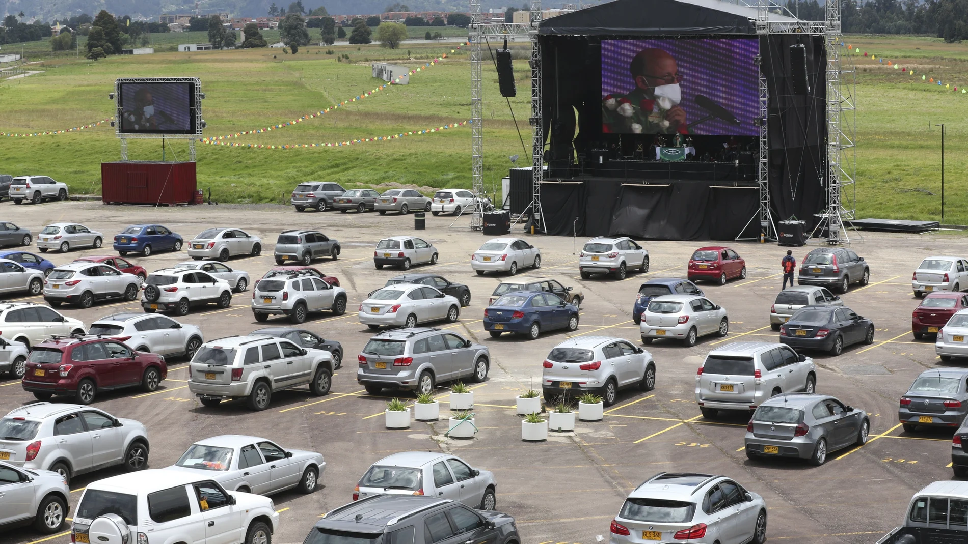 Catholic Priest Luis Carlos Ayala celebrates Mass at a drive-in as parishioners stay in their cars in Chia, Colombia, Sunday, Aug. 30, 2020. For the last three weeks, Father Ayala has been celebrating Mass in the parking lot of the city’s former horse racing track, now a venue that has been mostly used for concerts, movies, theater, and other outdoor presentations. (AP Photo/Fernando Vergara)